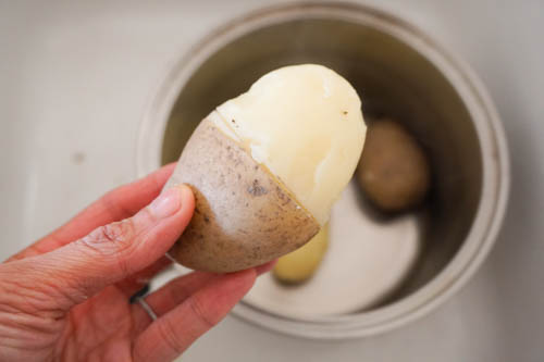 half peeled boiled potato
