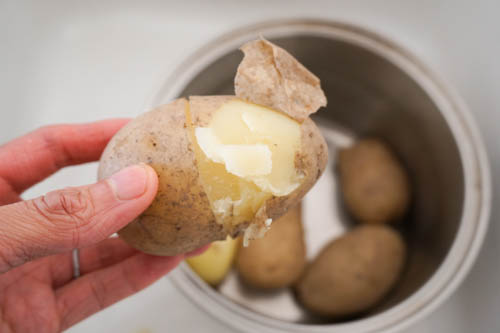 peeling boiled potato